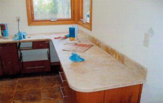Notice the radius comers of the cabinets that tie in the design of the shower. Natural stone is obviously the product of choice in this master bathroom.